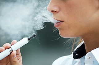 closeup of woman smoking electronic cigarette outdoor