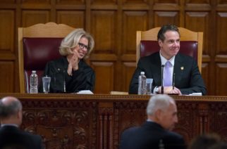 Chief Judge DiFiore sits with Gov. Andrew Cuomo.  Chief Judge DiFiore held a hearing this past week geared toward finding a solution to the civil justice crisis.