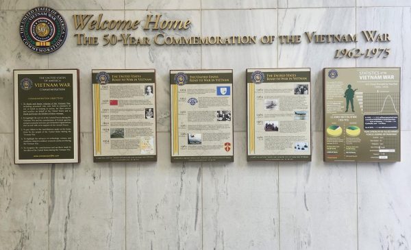 5 plaques at the entrance of the Empire State Plaza Vietnam Memorial with factoids about the war. only partially legible